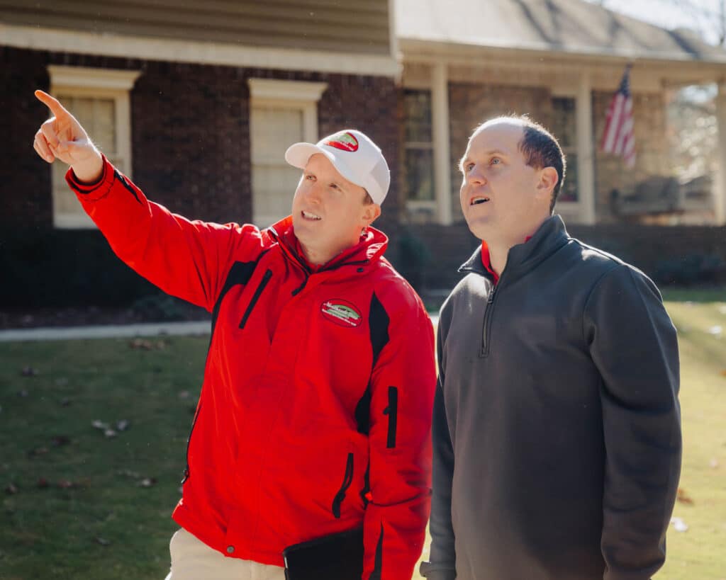 Homeowner consulting with a certified arborist about tree removal.